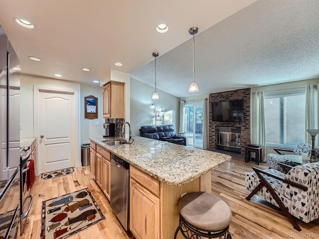 4063 S Cathay Ct, Aurora, CO 80013 - kitchen featuring stainless steel dishwasher, open floor plan, light brown cabinets, light wood-type flooring, and recessed lighting