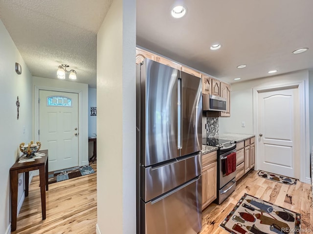 4063 S Cathay Ct, Aurora, CO 80013 - kitchen with appliances with stainless steel finishes, light wood finished floors, light brown cabinets, and recessed lighting