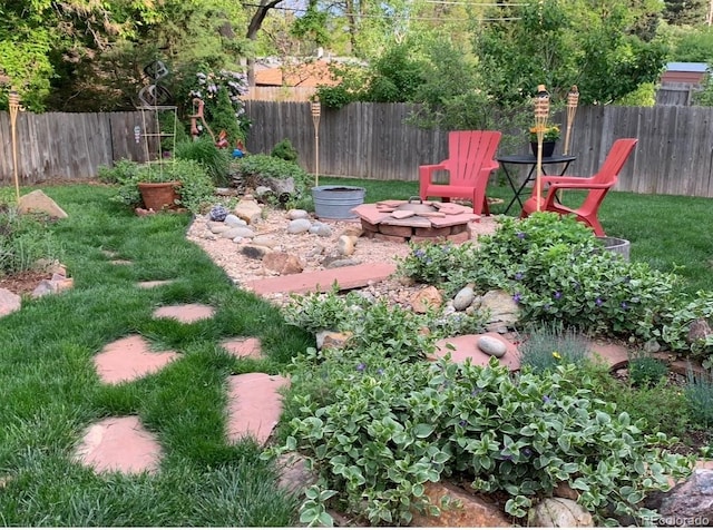 view of yard with a fire pit and fence