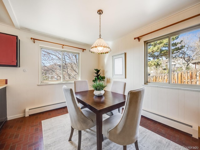 dining area featuring brick floor and a baseboard heating unit