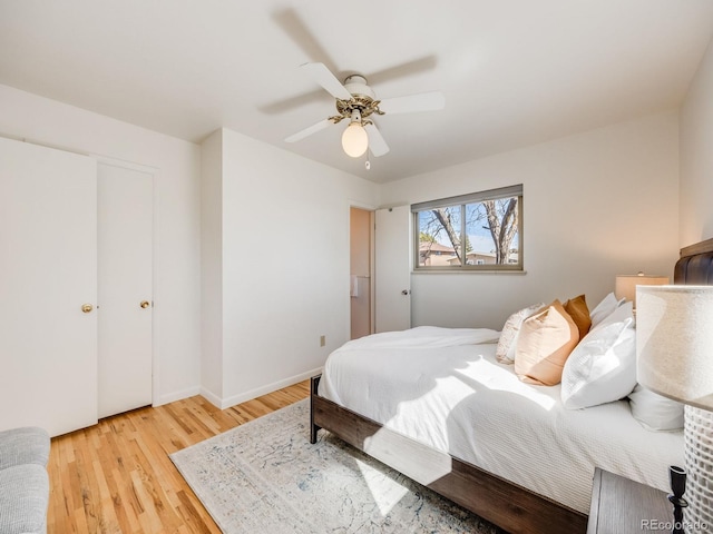 bedroom featuring baseboards, light wood-style floors, and ceiling fan