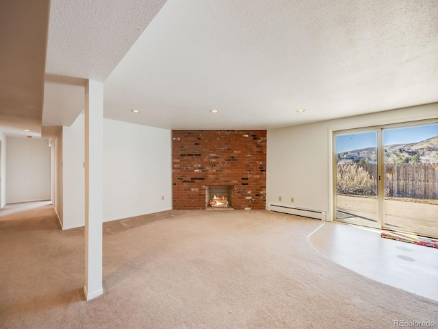 unfurnished living room with baseboard heating, a brick fireplace, a textured ceiling, and carpet