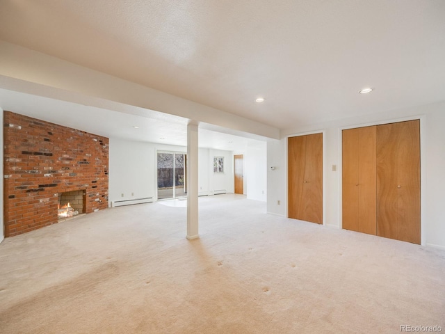 basement with recessed lighting, baseboard heating, a fireplace, and carpet flooring