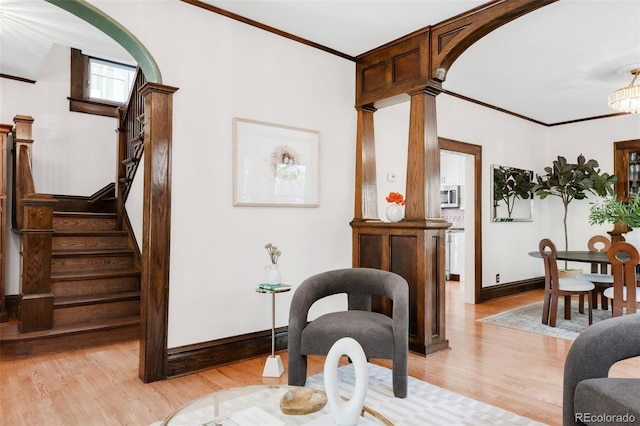 1220 S Vine St, Denver, CO 80210 - living room with arched walkways, light wood finished floors, baseboards, crown molding, and stairs