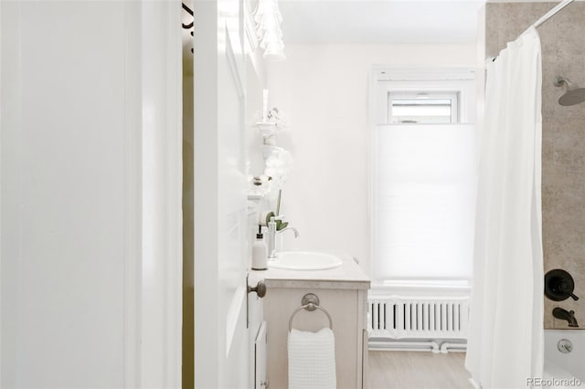1220 S Vine St, Denver, CO 80210 - full bath featuring radiator, vanity, and shower / tub combo