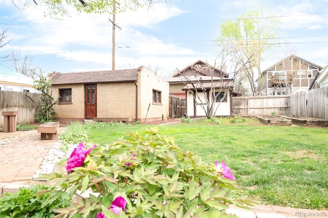 1220 S Vine St, Denver, CO 80210 - back of house featuring an outdoor structure, a vegetable garden, brick siding, and roof with shingles