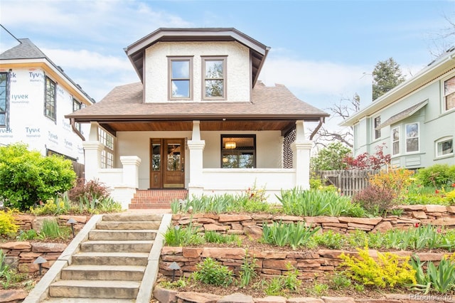 1220 S Vine St, Denver, CO 80210 - bungalow-style home featuring a shingled roof, a porch, and fence
