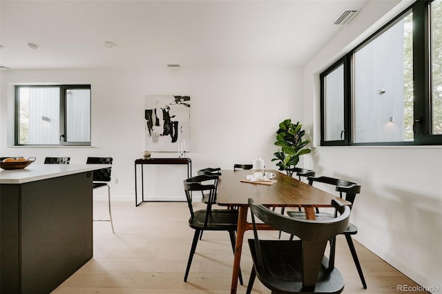 1601 Park Ave Unit 214, Denver, CO 80218 - dining room featuring baseboards and light wood-type flooring
