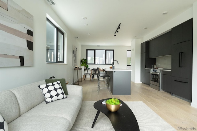 1601 Park Ave Unit 214, Denver, CO 80218 - living area featuring light wood-type flooring and rail lighting