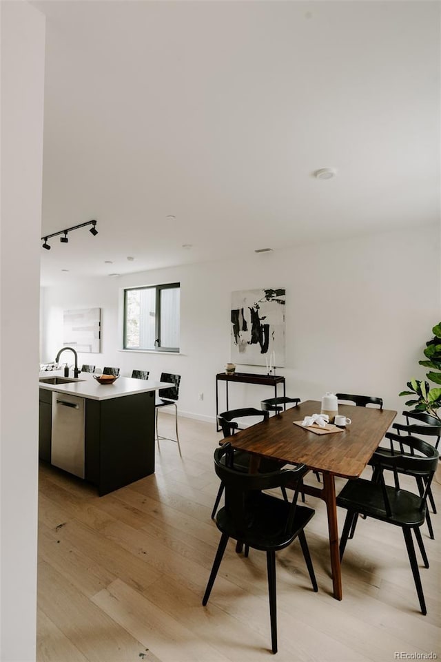 1601 Park Ave Unit 214, Denver, CO 80218 - dining room with light wood-style flooring and baseboards