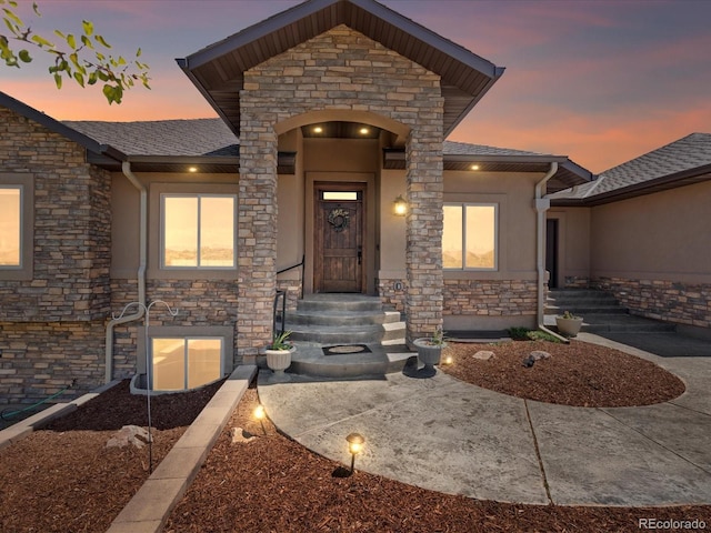 1505 Castlecombe Ln, Monument, CO 80132 - view of front of house with stone siding, stucco siding, and a shingled roof