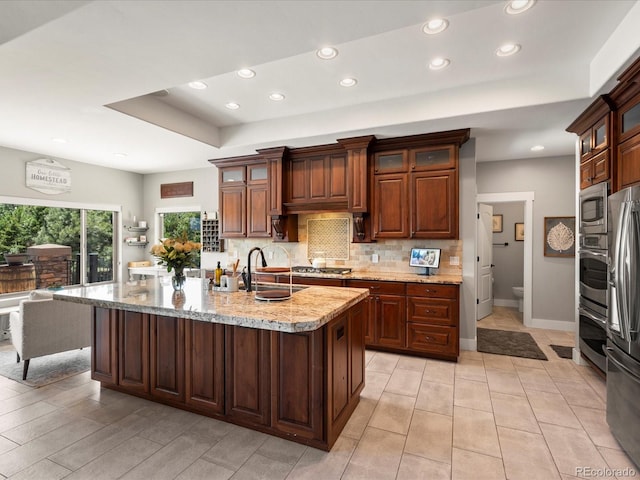 1505 Castlecombe Ln, Monument, CO 80132 - kitchen with appliances with stainless steel finishes, recessed lighting, backsplash, a raised ceiling, and baseboards