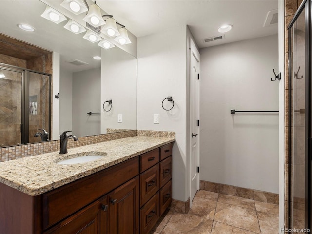 1505 Castlecombe Ln, Monument, CO 80132 - bathroom featuring a stall shower, vanity, baseboards, and backsplash