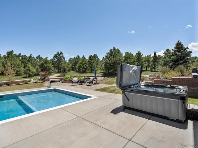 1505 Castlecombe Ln, Monument, CO 80132 - outdoor pool with a patio area and view of scattered trees