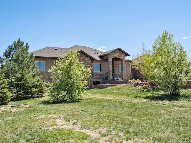 1505 Castlecombe Ln, Monument, CO 80132 - back of property with stone siding and a lawn