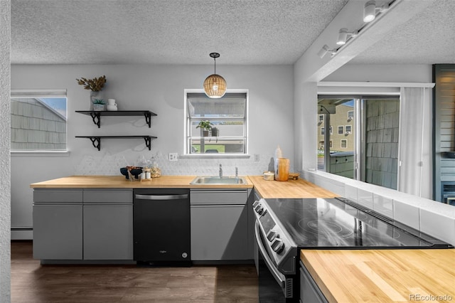 kitchen with range with electric cooktop, dishwashing machine, wooden counters, and a sink