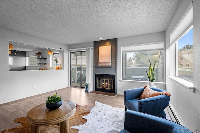 living area featuring a textured ceiling and a wealth of natural light