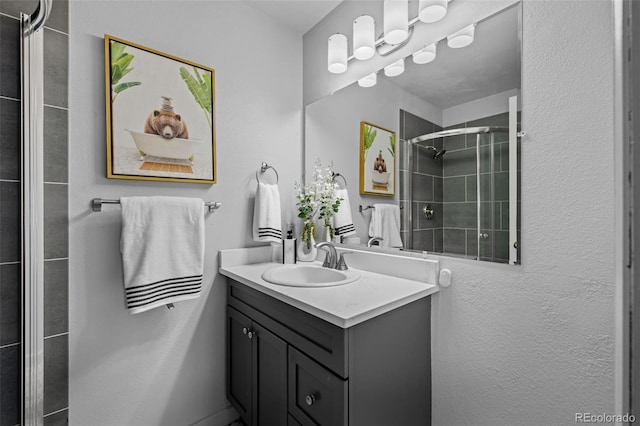 full bath featuring vanity and a tile shower