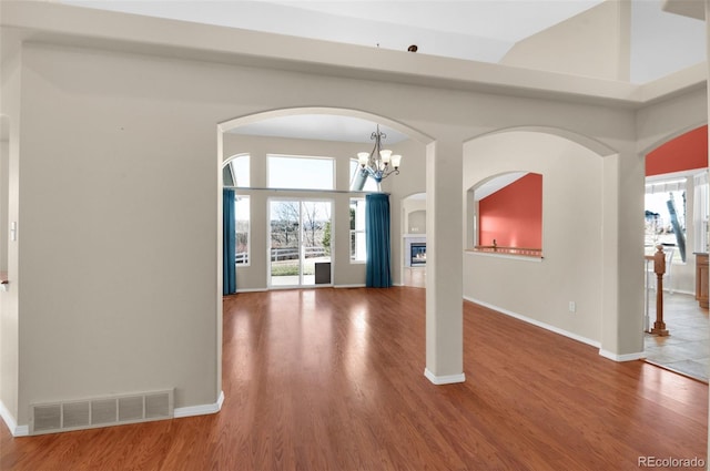 foyer featuring hardwood / wood-style floors, plenty of natural light, and a notable chandelier