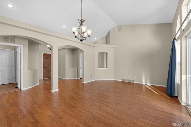 interior space with wood-type flooring and an inviting chandelier