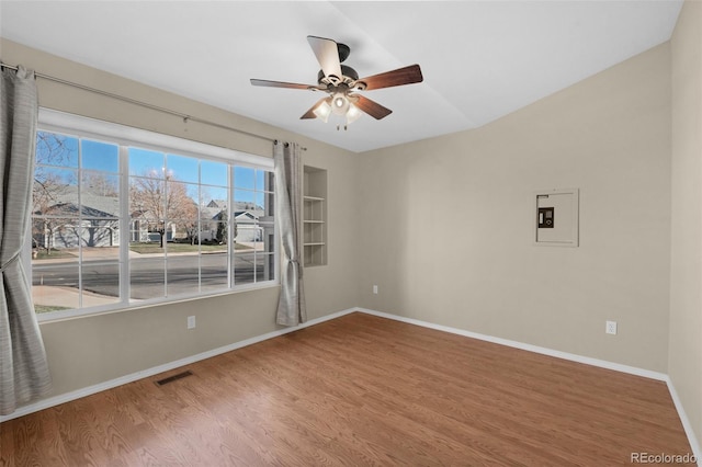 empty room with ceiling fan and hardwood / wood-style floors