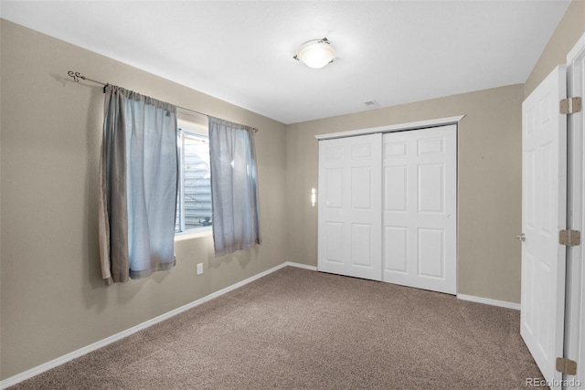 unfurnished bedroom featuring a closet and carpet