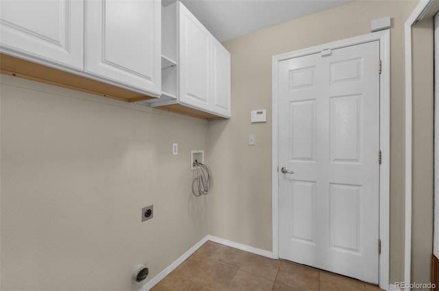 washroom with washer hookup, cabinets, light tile patterned floors, and hookup for an electric dryer