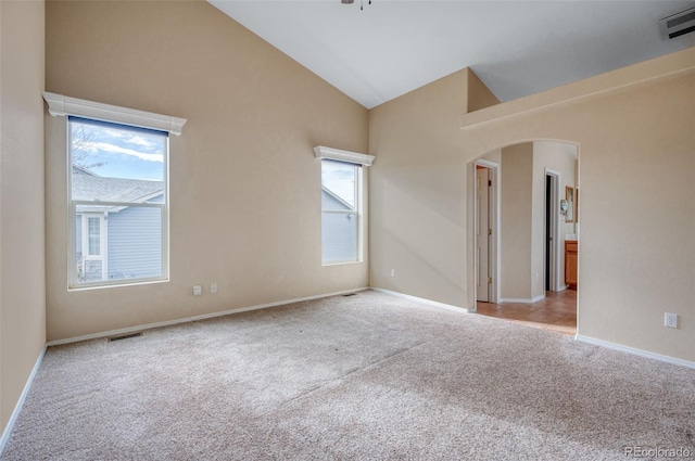 empty room featuring lofted ceiling and light colored carpet