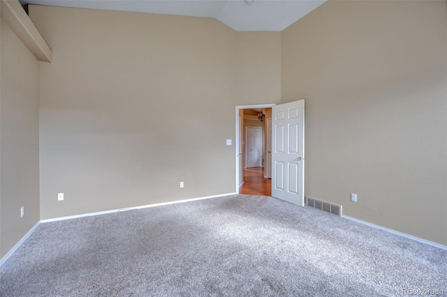 spare room with carpet and lofted ceiling