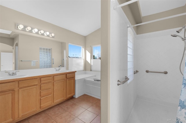 bathroom with lofted ceiling, vanity, tile patterned floors, and a bathing tub