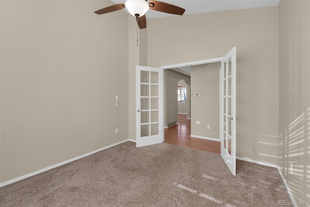 unfurnished room featuring ceiling fan, carpet, and french doors