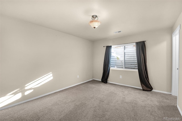 unfurnished room with light colored carpet