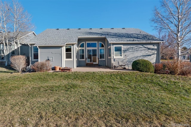 back of property with a lawn and a patio