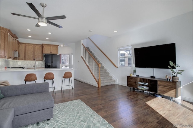 living room featuring dark hardwood / wood-style floors and ceiling fan