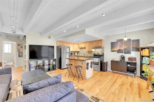 living room with beam ceiling, light wood-type flooring, and a textured ceiling