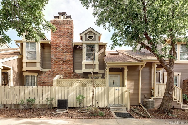 2082 S Helena St Unit C, Aurora, CO 80013 - view of front of property featuring a chimney and central AC unit