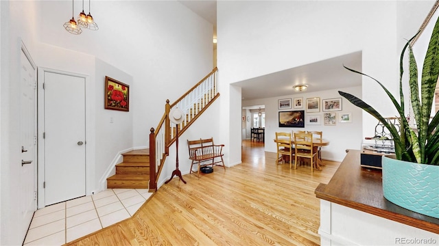 12201 N Holly Way, Brighton, CO 80602 - entrance foyer with stairway, wood finished floors, and a towering ceiling