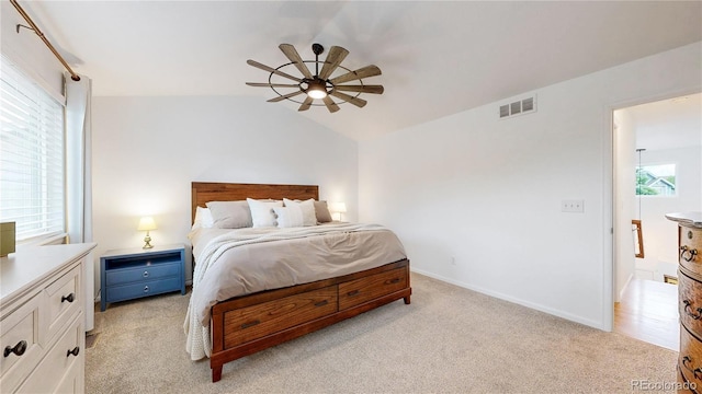 12201 N Holly Way, Brighton, CO 80602 - bedroom with light colored carpet, vaulted ceiling, ceiling fan, and baseboards