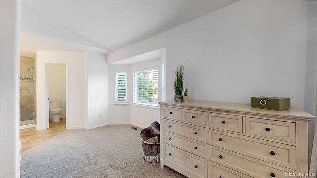 12201 N Holly Way, Brighton, CO 80602 - bedroom with light carpet, baseboards, vaulted ceiling, and connected bathroom