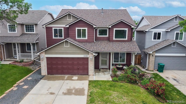 12201 N Holly Way, Brighton, CO 80602 - view of front facade with driveway, a porch, a shingled roof, and brick siding