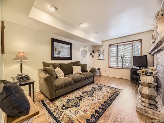 living room featuring a fireplace and light hardwood / wood-style flooring