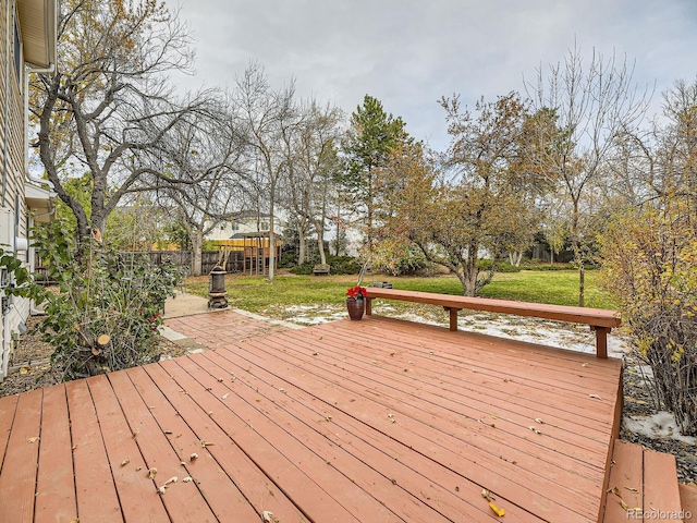 wooden terrace featuring a lawn