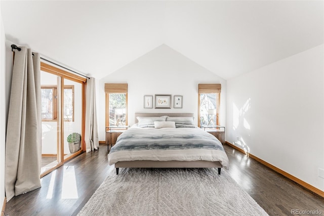 bedroom with dark wood-style floors, vaulted ceiling, and baseboards