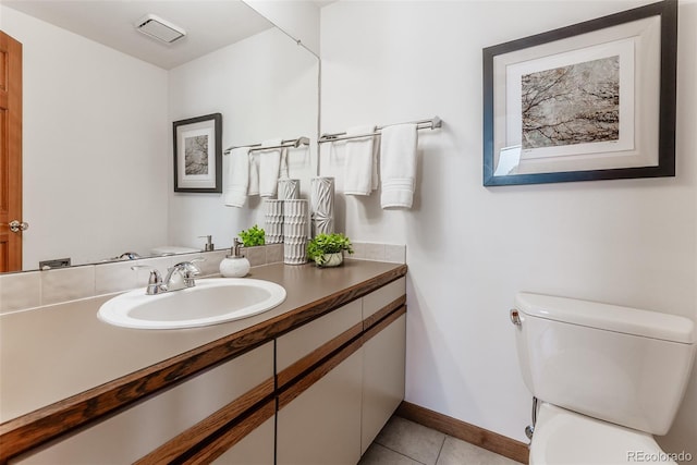 bathroom featuring tile patterned flooring, baseboards, vanity, and toilet