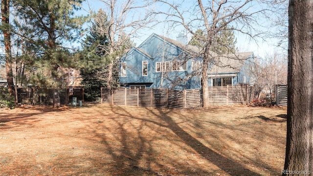 back of house with fence