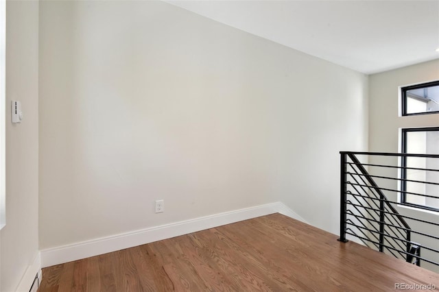 1563 N Hooker St, Denver, CO 80204 - empty room featuring wood finished floors and baseboards
