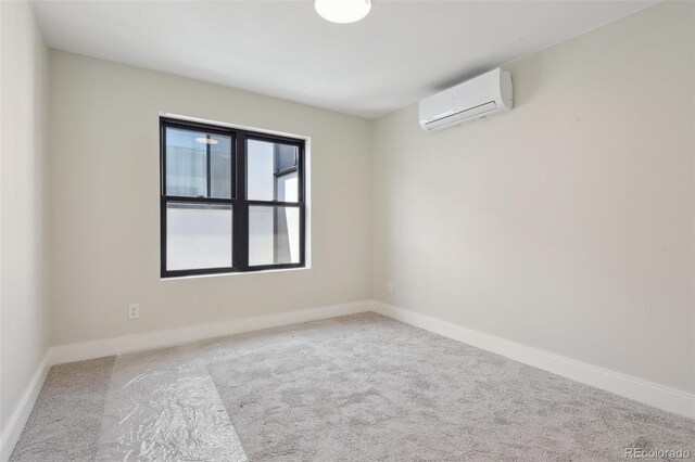 1563 N Hooker St, Denver, CO 80204 - carpeted empty room featuring a wall unit AC and baseboards