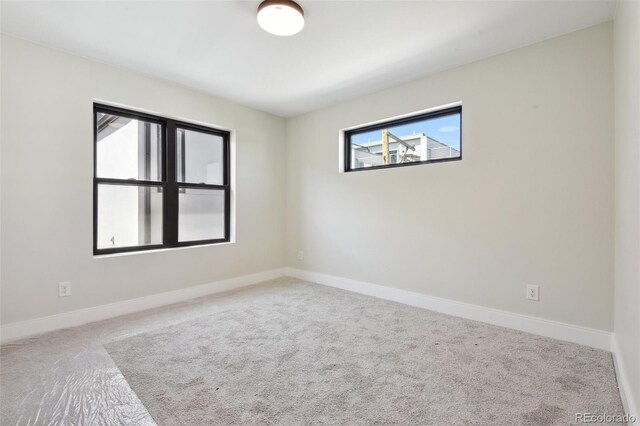 1563 N Hooker St, Denver, CO 80204 - carpeted spare room featuring baseboards