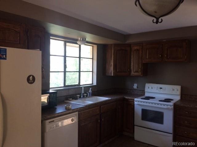1255 Yates St, Denver, CO 80204 - kitchen featuring white appliances and tile patterned flooring