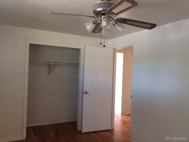 1255 Yates St, Denver, CO 80204 - unfurnished bedroom featuring wood finished floors, a closet, and a ceiling fan
